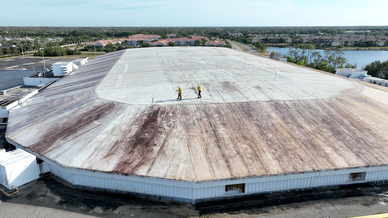 Stain Erasers technicians treating the white TPO roof of the Hertz Arena